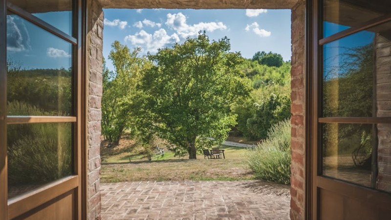 Admire the lush Italian landscape through a classic stone doorway in Umbria. - Admire the lush Italian landscape through a classic stone doorway in Umbria., tags: la vita - pexel